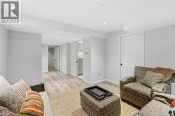 Living room featuring light wood-style flooring and recessed lighting - 