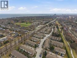 Aerial view of residential area featuring a large body of water - 