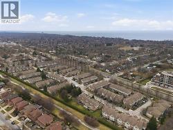 Aerial perspective of suburban area featuring a large body of water - 