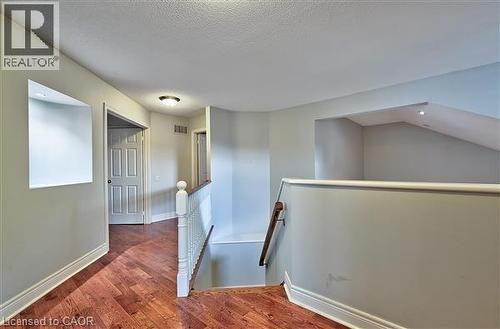Hall with an upstairs landing, dark wood-style flooring, and a textured ceiling - 2215 Tiger Road, Burlington, ON - Indoor Photo Showing Other Room