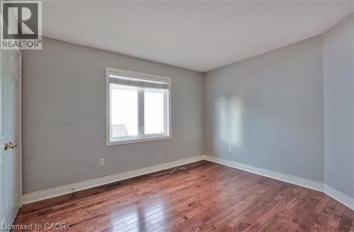 Empty room with dark wood finished floors and baseboards - 2215 Tiger Road, Burlington, ON - Indoor Photo Showing Other Room
