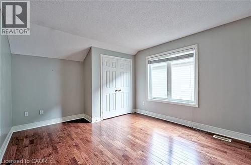 Unfurnished bedroom with dark wood-style flooring and a closet - 2215 Tiger Road, Burlington, ON - Indoor Photo Showing Other Room