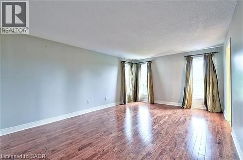 Spare room with dark wood-style flooring and a textured ceiling - 2215 Tiger Road, Burlington, ON - Indoor Photo Showing Other Room