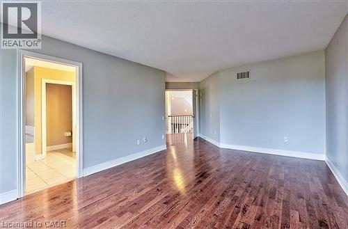 Empty room featuring dark wood finished floors and baseboards - 2215 Tiger Road, Burlington, ON - Indoor Photo Showing Other Room