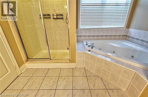 Bathroom with a stall shower, a whirlpool tub, and tile patterned floors - 2215 Tiger Road, Burlington, ON - Indoor Photo Showing Bathroom