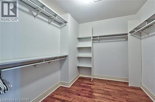 Walk in closet with dark wood finished floors - 2215 Tiger Road, Burlington, ON - Indoor With Storage