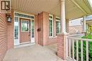 Property entrance featuring covered porch and brick siding - 2215 Tiger Road, Burlington, ON  - Outdoor With Exterior 
