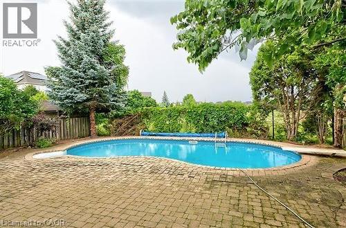 View of pool with a fenced backyard and patio surround - 2215 Tiger Road, Burlington, ON - Outdoor With In Ground Pool With Backyard