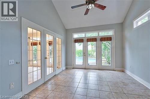 Doorway with french doors, ceiling fan, vaulted ceiling, and tile patterned floors - 2215 Tiger Road, Burlington, ON - Indoor Photo Showing Other Room