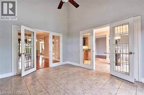 Unfurnished room with french doors, light tile patterned flooring, ceiling fan, and a high ceiling - 2215 Tiger Road, Burlington, ON - Indoor Photo Showing Other Room