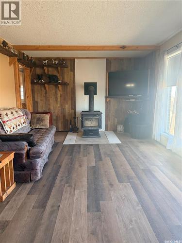 Mezzo Acreage Grid Road, Tompkins, SK - Indoor Photo Showing Living Room With Fireplace
