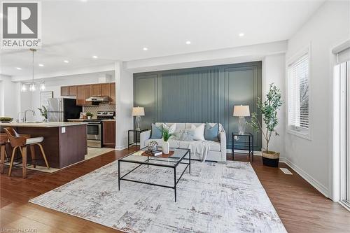 Feature accent wall provides built-in depth and style. - 122 E Dundas Street E Unit# 9, Waterdown, ON - Indoor Photo Showing Living Room