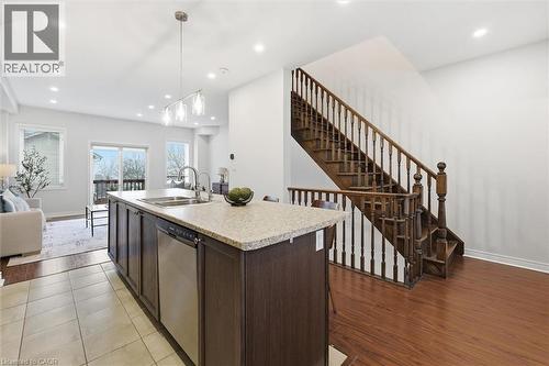 Stainless steel dishwasher, pendent lighting, additional storage and convenient outlets. - 122 E Dundas Street E Unit# 9, Waterdown, ON - Indoor Photo Showing Kitchen With Double Sink