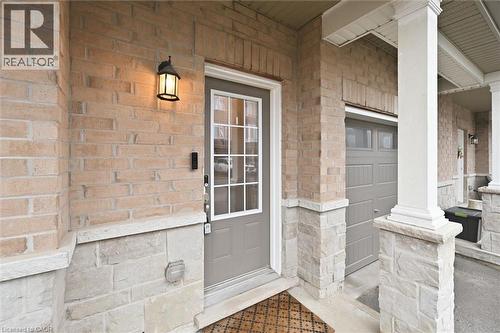 Property entrance featuring a porch and a garage - 122 E Dundas Street E Unit# 9, Waterdown, ON -  With Exterior