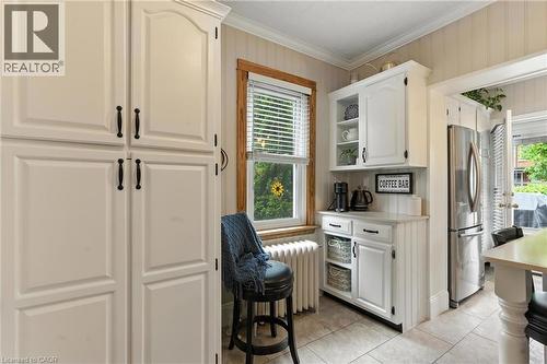 Kitchen featuring white cabinets, quartz countertops, crown molding - 98 Kensington Avenue S, Hamilton, ON - Indoor Photo Showing Other Room