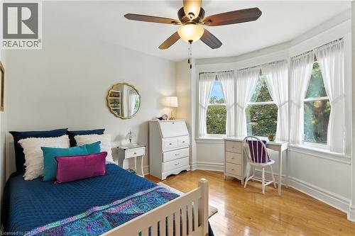 Bedroom with hardwood  floors and a bright window - 98 Kensington Avenue S, Hamilton, ON - Indoor Photo Showing Bedroom