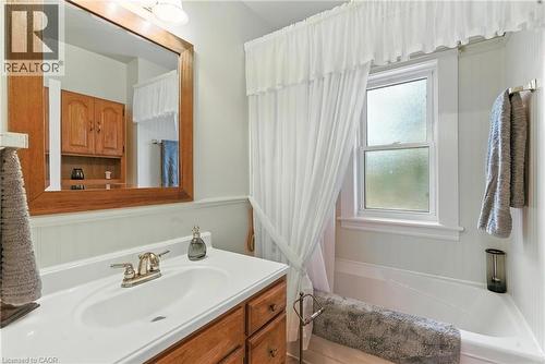 Bathroom with vanity and shower / bathtub combination with curtain - 98 Kensington Avenue S, Hamilton, ON - Indoor Photo Showing Bathroom
