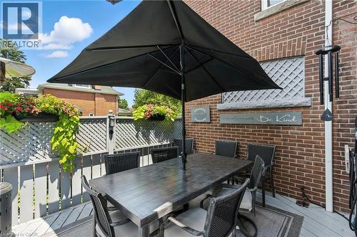 Wooden terrace with outdoor dining space - 98 Kensington Avenue S, Hamilton, ON - Outdoor With Deck Patio Veranda With Exterior