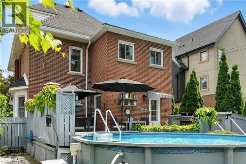 Back of house featuring an outdoor pool, and a patio area - 98 Kensington Avenue S, Hamilton, ON - Outdoor With Above Ground Pool