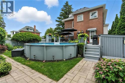 Back of property with a patio - 98 Kensington Avenue S, Hamilton, ON - Outdoor With Above Ground Pool