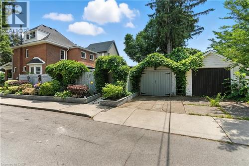 View of property exterior featuring a garage and driveway space - 98 Kensington Avenue S, Hamilton, ON - Outdoor