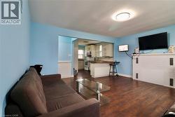 Living area with dark wood finished floors and wainscoting - 