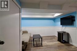 Sitting room with wainscoting and wood finished floors - 