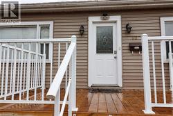 View of exterior entry with a wooden deck - 