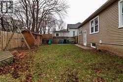Fenced backyard featuring a storage unit - 