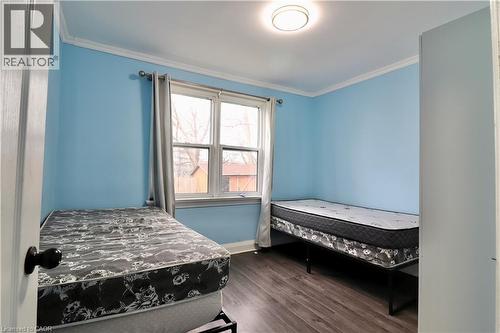 Bedroom featuring dark wood-style floors and crown molding - 80 Roseview Avenue, Cambridge, ON - Indoor Photo Showing Bedroom