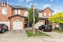 Traditional-style house with brick siding, driveway, roof with shingles, and a garage - 311 Highway 8 Unit# 12, Stoney Creek, ON  - Outdoor With Facade 