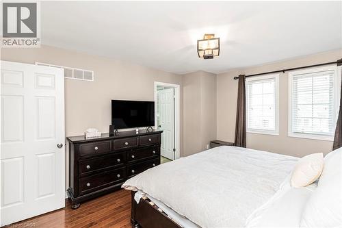 Bedroom with dark wood finished floors - 311 Highway 8 Unit# 12, Stoney Creek, ON - Indoor Photo Showing Bedroom