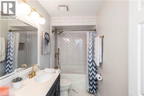 Bathroom featuring vanity, shower / tub combo with curtain, and marble finish floors - 311 Highway 8 Unit# 12, Stoney Creek, ON - Indoor Photo Showing Bathroom