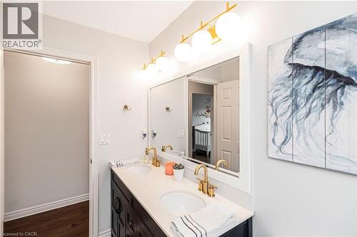 Full bathroom featuring double vanity and dark wood-style floors - 311 Highway 8 Unit# 12, Stoney Creek, ON - Indoor Photo Showing Bathroom