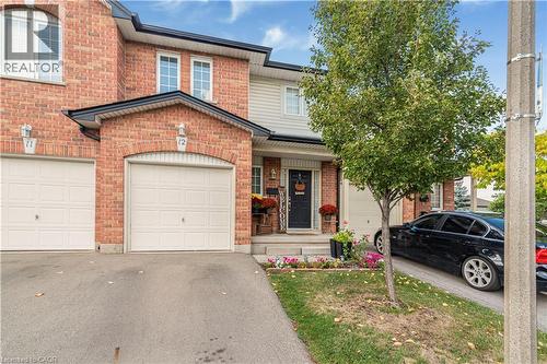 Traditional home with driveway, brick siding, a porch, and a garage - 311 Highway 8 Unit# 12, Stoney Creek, ON - Outdoor