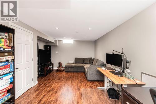 Living area featuring dark wood-style floors and an office area - 311 Highway 8 Unit# 12, Stoney Creek, ON - Indoor Photo Showing Other Room