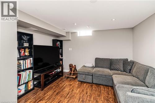 Living room with dark wood finished floors - 311 Highway 8 Unit# 12, Stoney Creek, ON - Indoor Photo Showing Basement