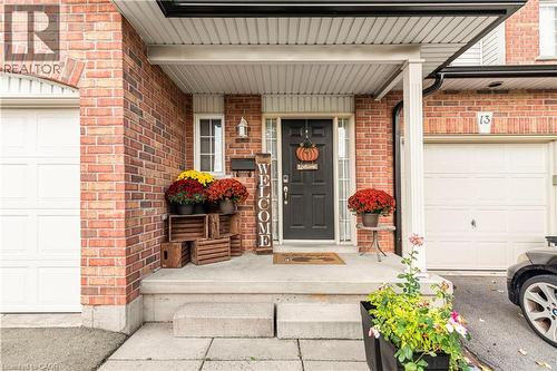 Doorway to property featuring brick siding and covered porch - 311 Highway 8 Unit# 12, Stoney Creek, ON - Outdoor With Exterior