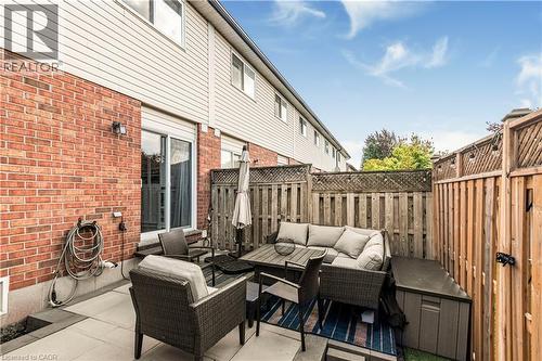 Fenced backyard with an outdoor lounge area and a patio area - 311 Highway 8 Unit# 12, Stoney Creek, ON - Outdoor With Deck Patio Veranda With Exterior