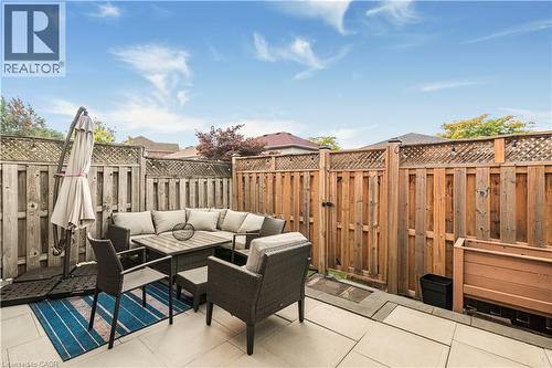 Fenced backyard with an outdoor living space, a gate, and a patio area - 311 Highway 8 Unit# 12, Stoney Creek, ON - Outdoor
