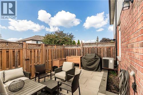 Fenced backyard with an outdoor lounge area, a patio area, area for grilling, and a hot tub - 311 Highway 8 Unit# 12, Stoney Creek, ON - Outdoor With Deck Patio Veranda With Exterior