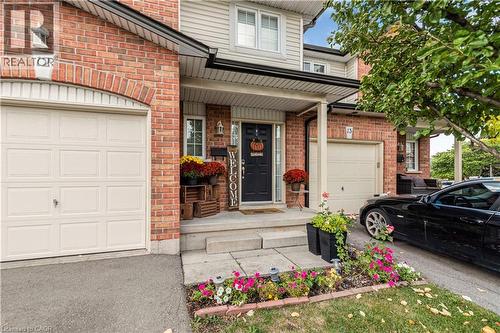Entrance to property with brick siding, covered porch, and a garage - 311 Highway 8 Unit# 12, Stoney Creek, ON - Outdoor