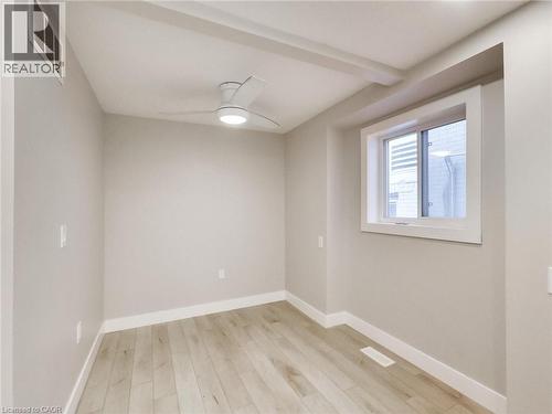 A bright and airy room with light-colored flooring, a window, and a ceiling fan with integrated lighting - 229 Parkdale Avenue N, Hamilton, ON 