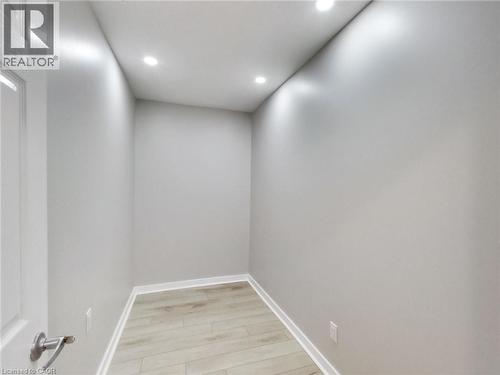 This room features light-toned flooring, white baseboards, and recessed lighting fixtures - 229 Parkdale Avenue N, Hamilton, ON 