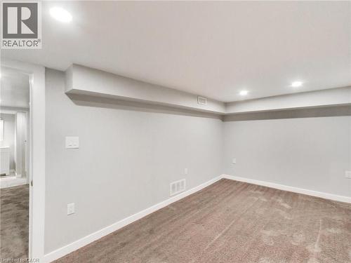Spacious room with recessed lighting and neutral-toned carpeting - 229 Parkdale Avenue N, Hamilton, ON 