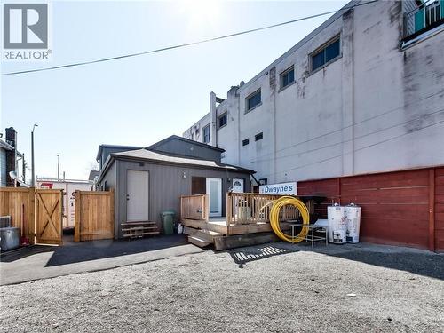 The property features a private fenced area with a wooden deck and exterior door - 229 Parkdale Avenue N, Hamilton, ON 