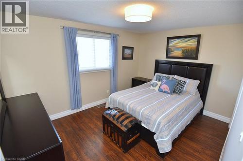 Bedroom with dark wood-style floors and a textured ceiling - 2206 Donald Road, Burlington, ON - Indoor Photo Showing Bedroom