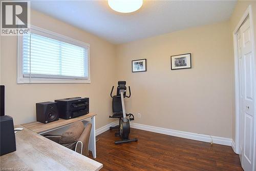 Workout area with dark wood finished floors and baseboards - 2206 Donald Road, Burlington, ON - Indoor