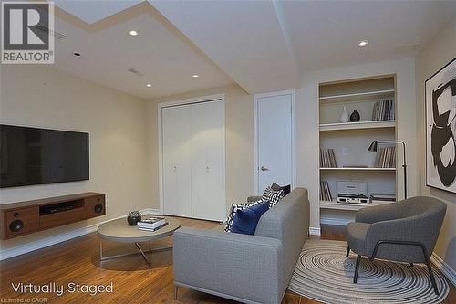 Living room with built in shelves, dark wood finished floors, and recessed lighting - 2206 Donald Road, Burlington, ON - Indoor Photo Showing Living Room