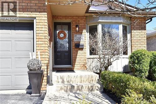 View of exterior entry featuring brick siding and a garage - 2206 Donald Road, Burlington, ON - Outdoor